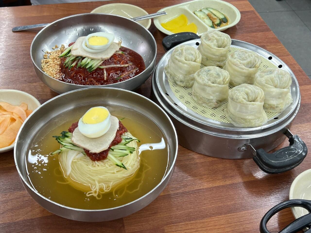 
                        🇰🇷 釜山美味探店 // 当地人也疯狂的超值冷面 🍜🏠 초량밀면📍 부산 동구 중앙대로 225踏入釜山的第一站，我就直奔这家冷面店，仿佛成了不成文的规矩，哈哈哈，大家都这么做呢！🚄 火车站旁边的绝佳位置，让你可以一下车就闻到冷面的香气，不少人拖着行李箱就来排队了，门口的行李箱山可是一绝景呢！😆性价比超高的一大亮点！份量超级给力，吃得超满足！👍说到口味，我个人偏爱拌冷面多一些。那独特的酱料，第一次尝试就让人难忘，仿佛里面混合了花生碎，香气扑鼻！面条也是软硬适中，不需要剪刀就能轻松享用，这样的口感我更加喜欢！饺子也是赞一个，个大味美，几乎要比外面的两倍还要大呢！回到首尔后，这家冷面店的味道还在脑海中挥之不去，真的很有釜山的风味，强烈推荐给大家！👏#釜山美食 #韩国美食 #韩国探店 #釜山探店 #釜山旅行 🌟